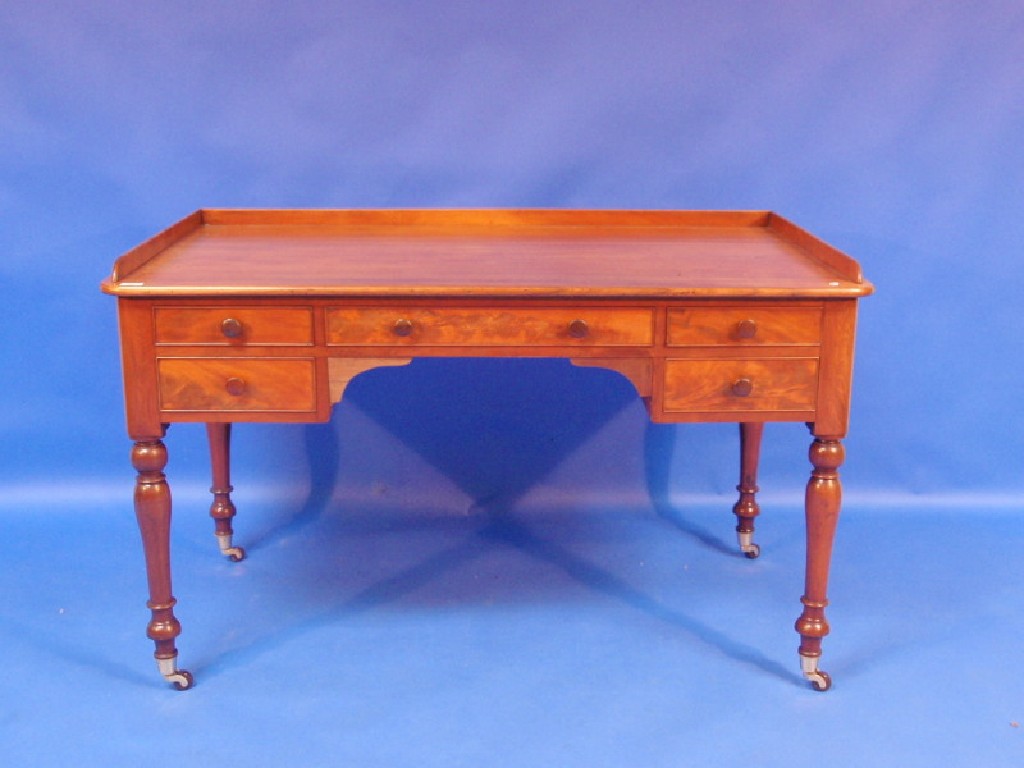 Appraisal: A thC figured mahogany kneehole desk with plain low gallery