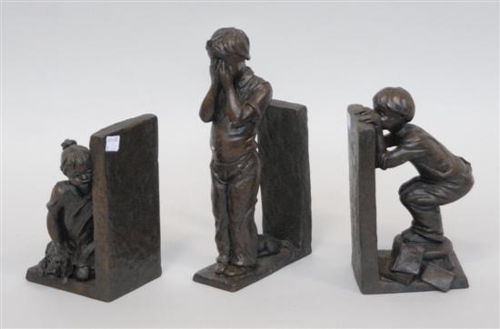 Appraisal: THREE BRONZED FIGURAL BOOKENDS Depicting children H largest