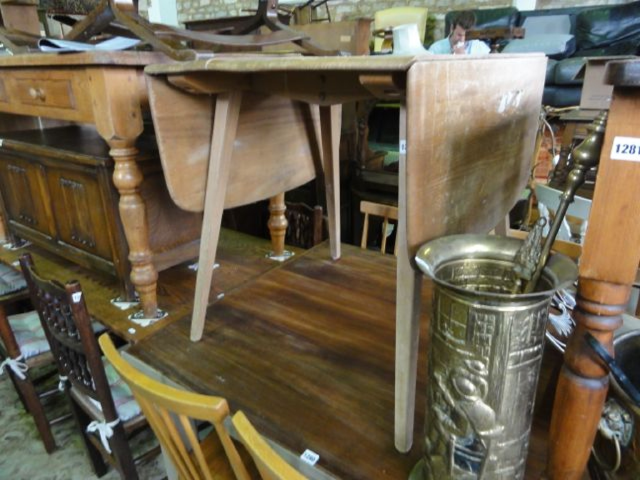 Appraisal: An Ercol elm and beechwood drop leaf kitchen table raised