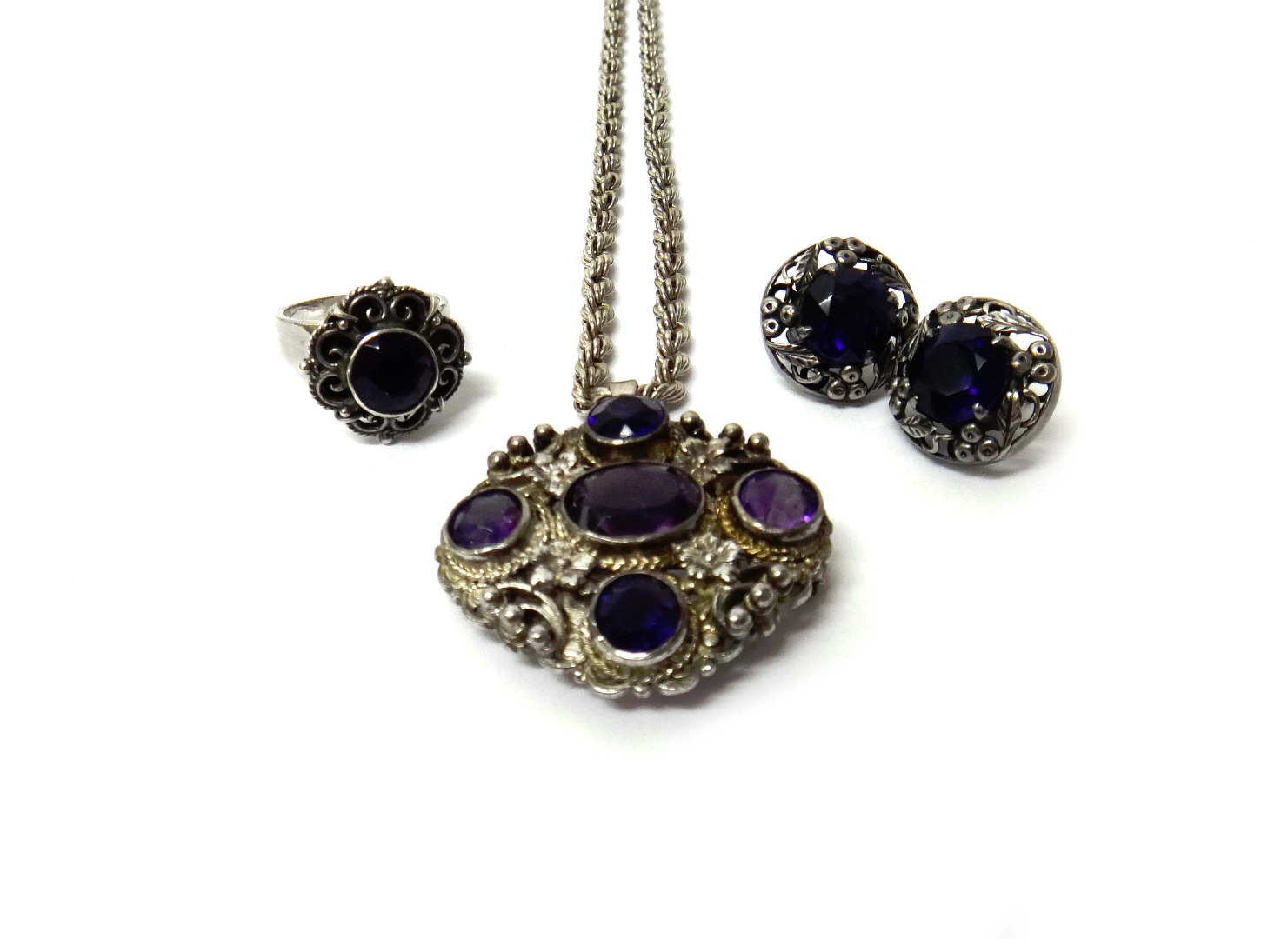 Appraisal: A silver and amethyst set five stone pendant brooch fitted