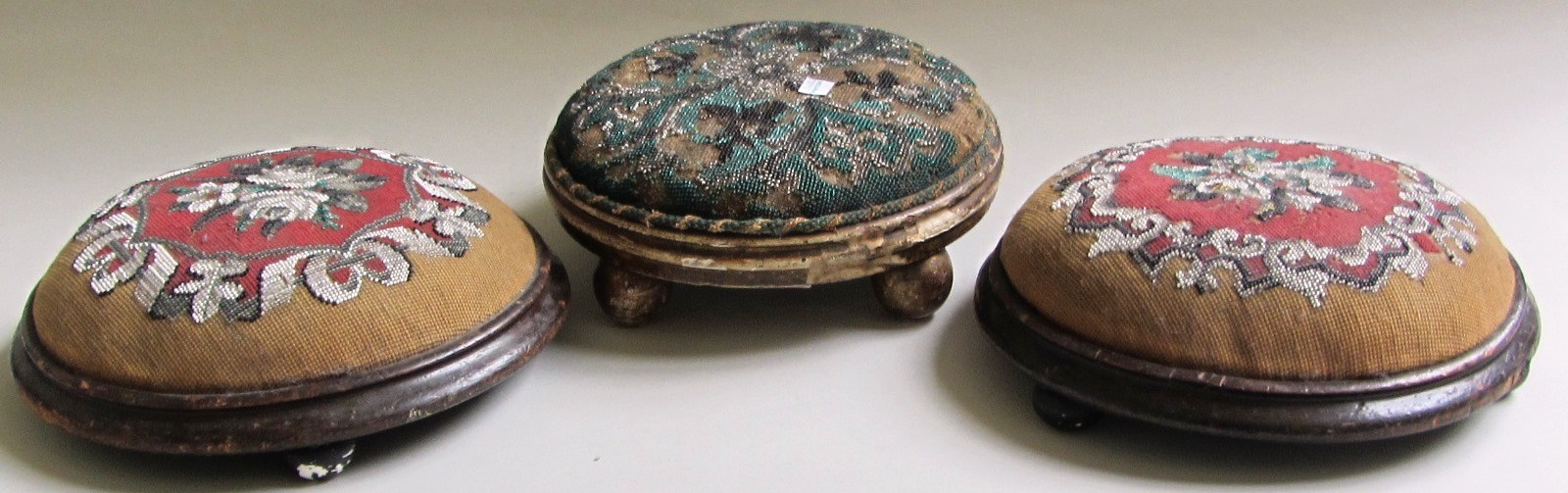 Appraisal: A pair of Victorian circular foot stools with tapestry tops