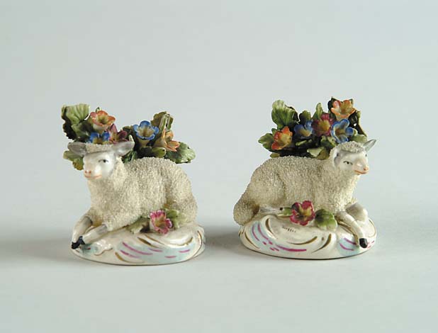 Appraisal: PAIR OF STAFFORDSHIRE SHEEP FIGURINES Round bases have sheep laying