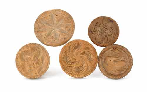 Appraisal: Five Pennsylvania carved wooden butter molds th th c to