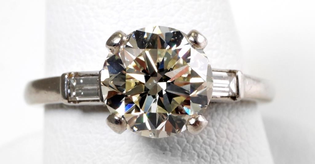 Appraisal: Bold carat diamond ring flanked by diamond baguettes set in