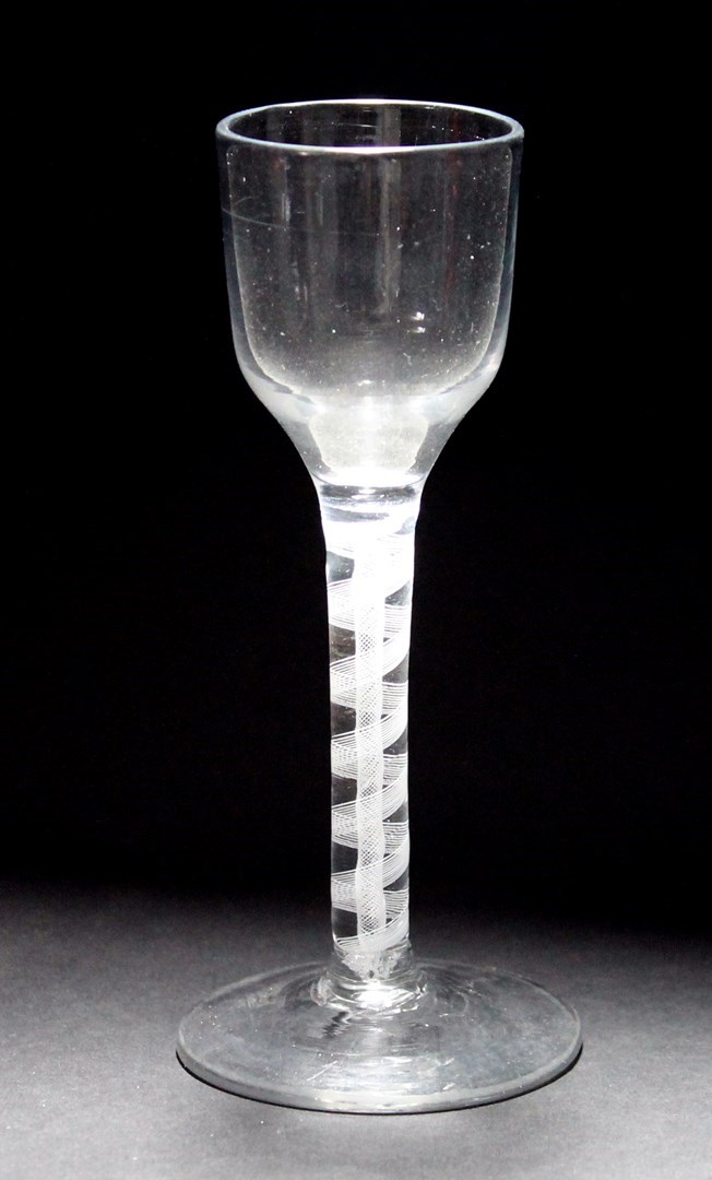 Appraisal: An opaque twist wine glass circa the ogee bowl raised