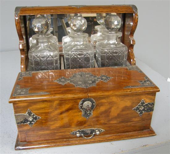 Appraisal: Early th century oak and silver plated three decanter tantalus