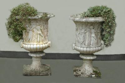 Appraisal: A PAIR OF COMPOSITION STONE URNS in the manner of