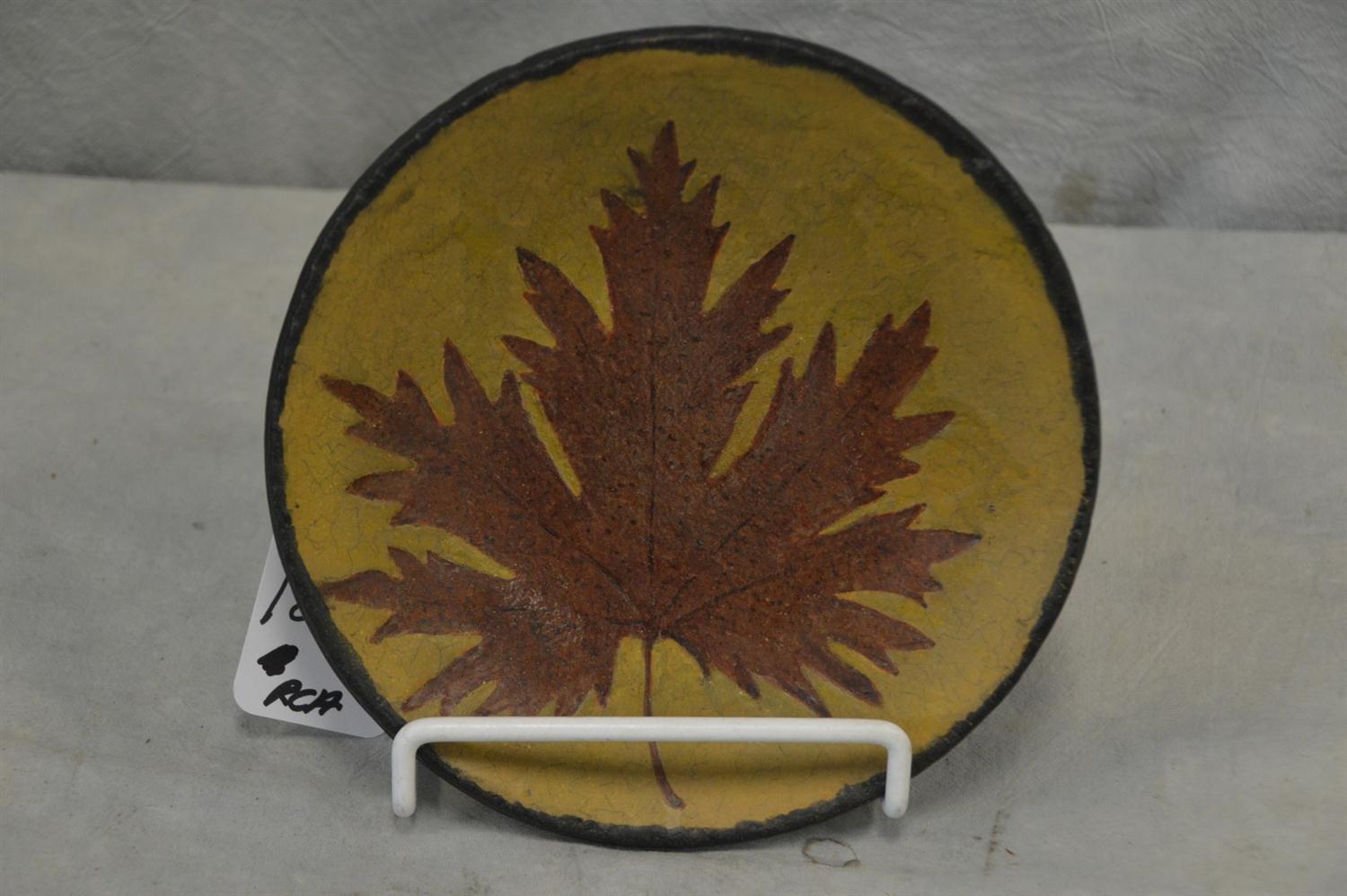 Appraisal: Redware plate leaf design yellow slip large chip on back