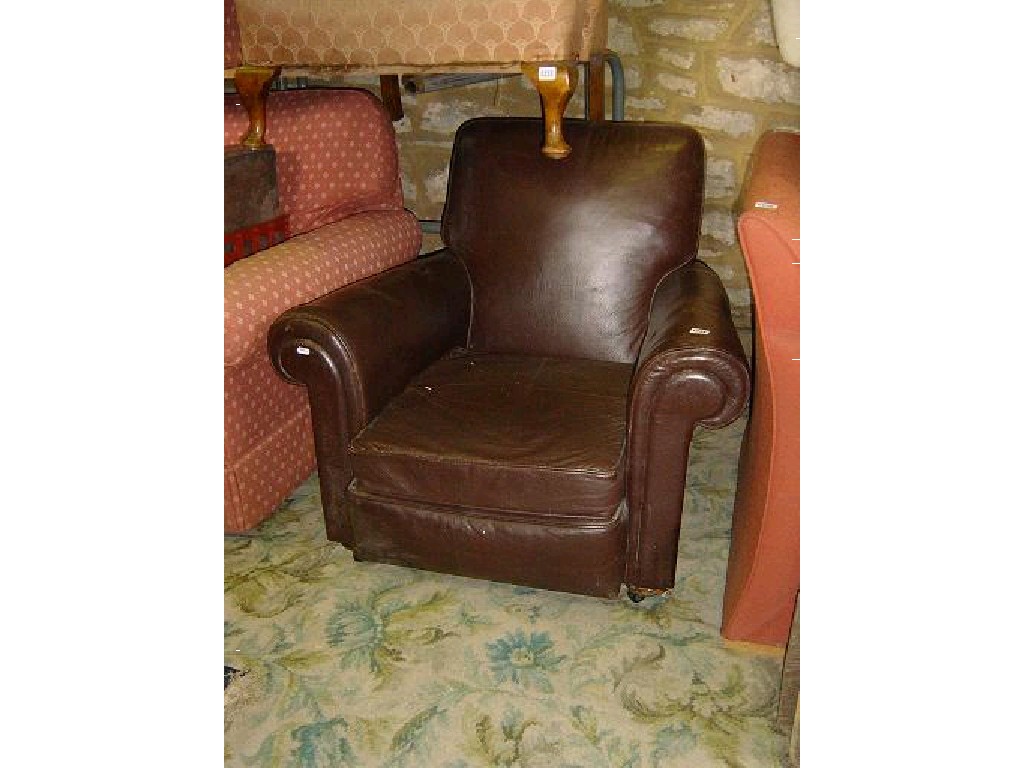 Appraisal: An Edwardian brown leather upholstered easy chair with rolled arms