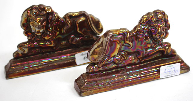 Appraisal: A PAIR OF CAST IRON ENAMEL DECORATED DOOR STOPS in