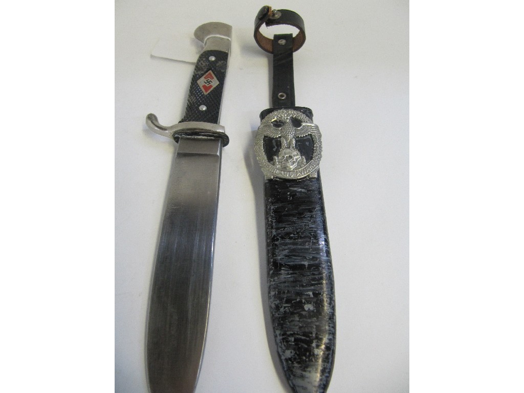 Appraisal: A Hitler Youth Dagger in scabbard with a badge -