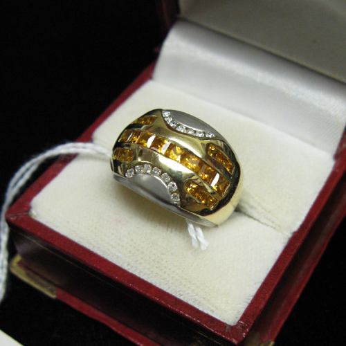 Appraisal: A DIAMOND YELLOW TOPAZ FOURTEEN KARAT YELLOW AND WHITE GOLD