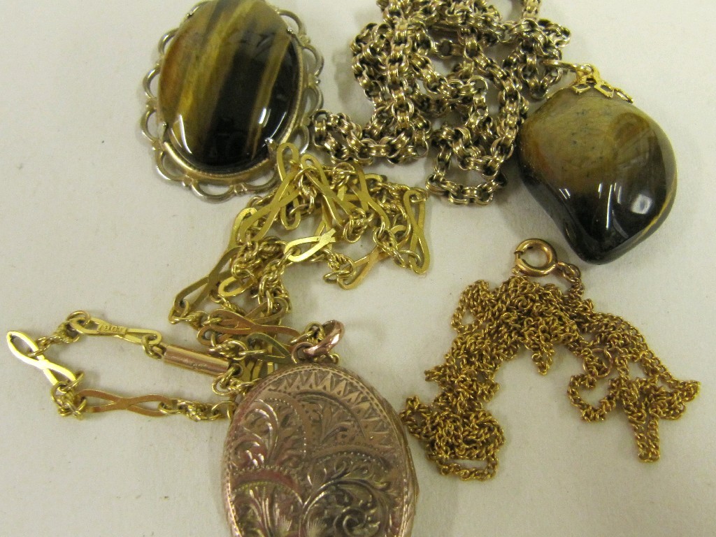 Appraisal: Lot comprising two tigers eye pendants two ct gold neckchains