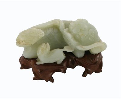 Appraisal: A Chinese jade carving of a recumbent Buddhist lion holding