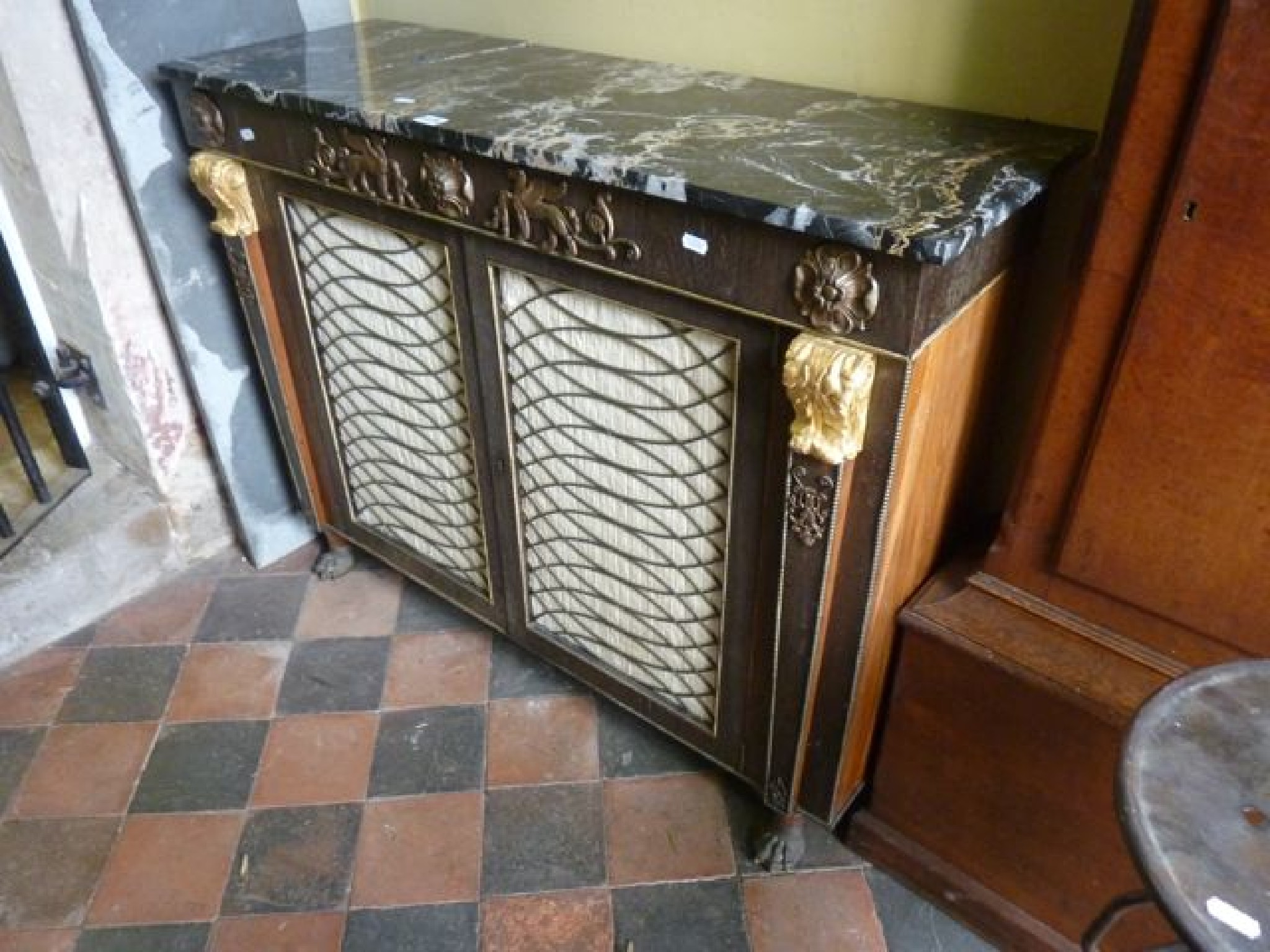 Appraisal: A Regency style chiffonier enclosed by two doors with pleated