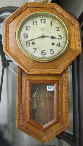 Appraisal: AN OAK SCHOOL HOUSE REGULATOR WALL CLOCK having an octagonal