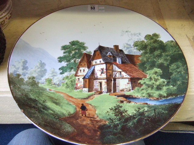 Appraisal: A large Continental earthenware charger decorated with a rural scene