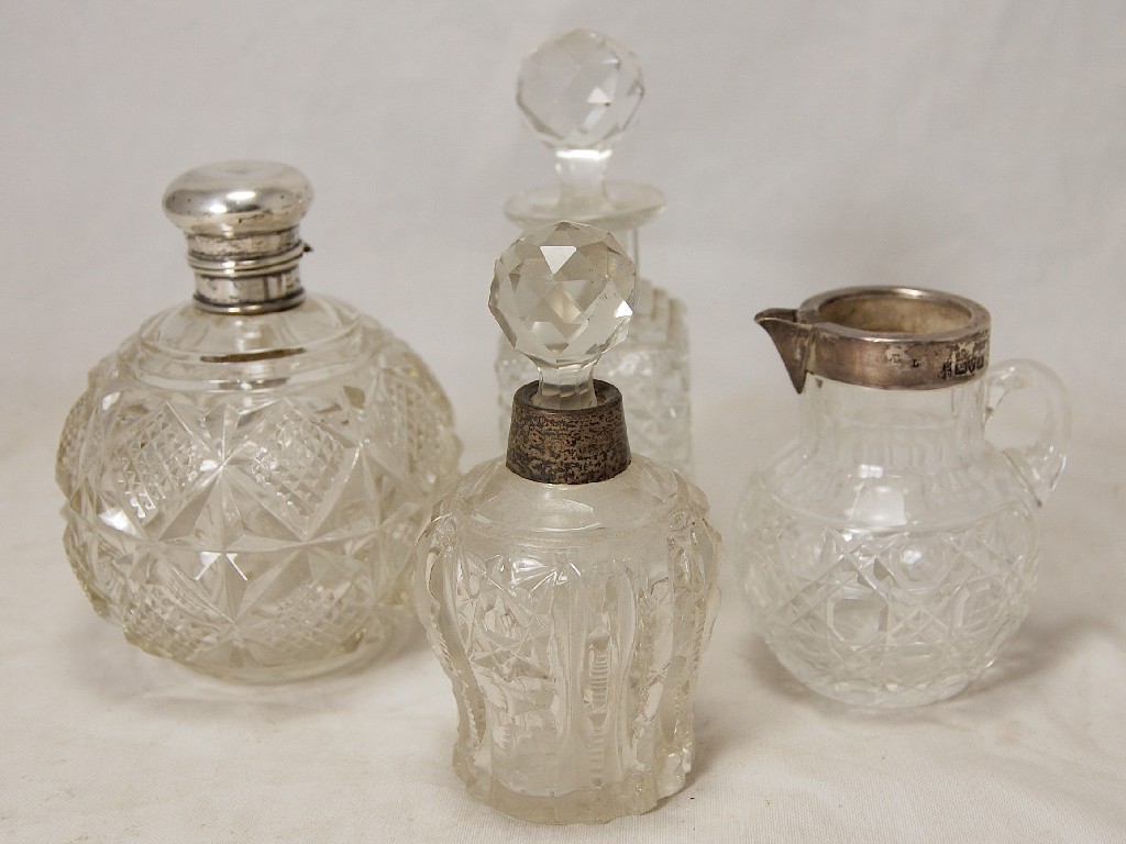 Appraisal: Circular cut glass scent bottle with hinged silver lid cut