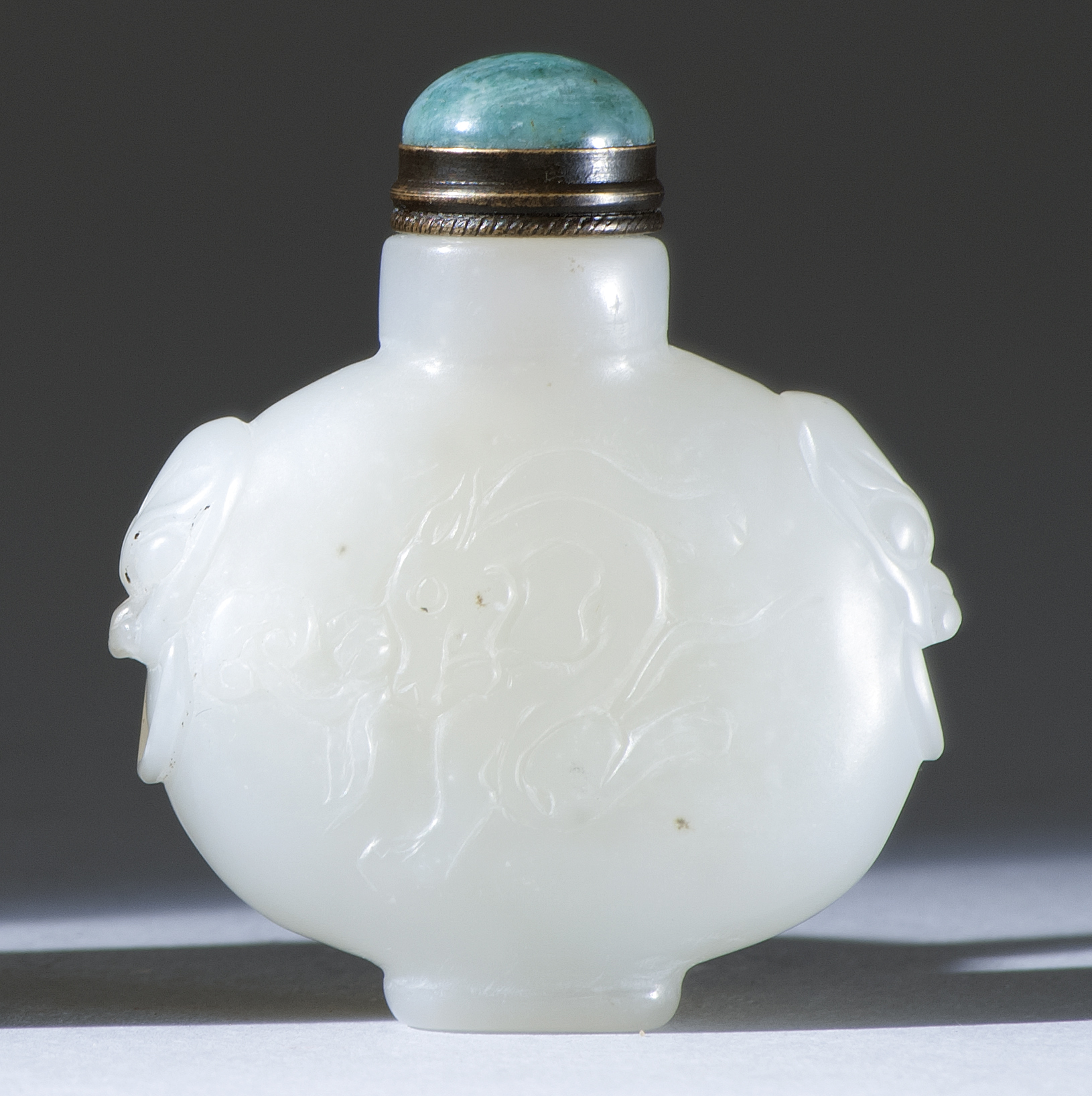 Appraisal: WHITE JADE SNUFF BOTTLE In flattened ovoid form with mask