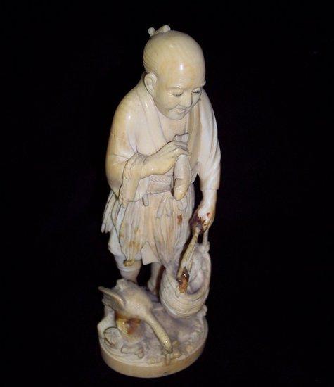 Appraisal: An ivory okimono Meiji period modelled as a man with