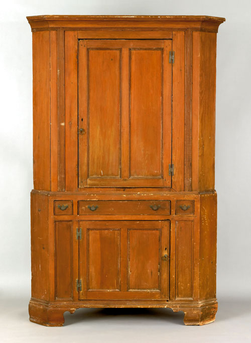 Appraisal: Pennsylvania pine two-part corner cupboard late th c the molded