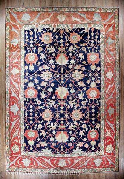 Appraisal: A Persian Serapi Carpet navy and crimson ground central bold