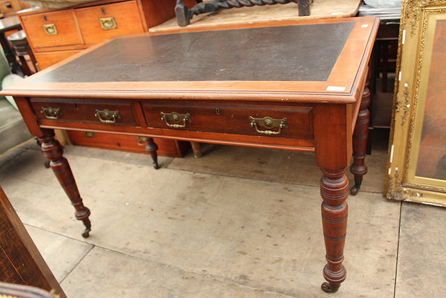 Appraisal: A VICTORIAN WALNUT WRITING TABLE with black leatherette inset top