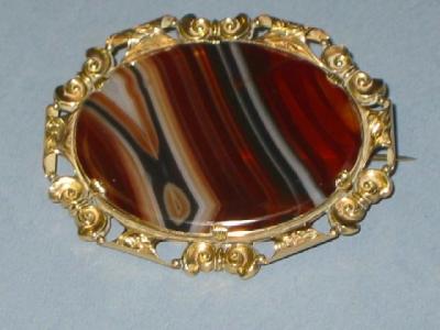 Appraisal: A VICTORIAN AGATE BROOCH the striped polished oval set within