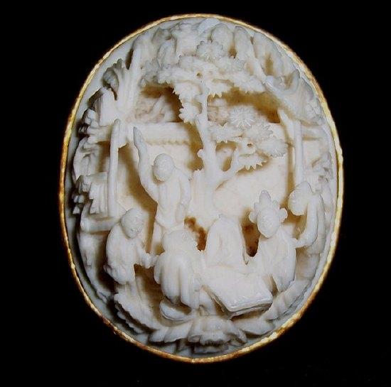 Appraisal: An Oriental carved ivory brooch depicting figures by trees and