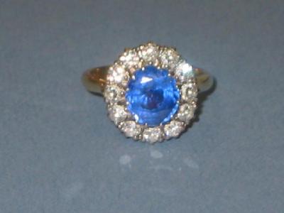 Appraisal: A SAPPHIRE AND DIAMOND CLUSTER RING the pale blue oval