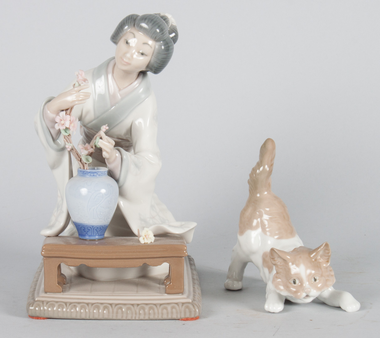 Appraisal: Two Lladro porcelain figures Geisha Arranging Flowers in H and