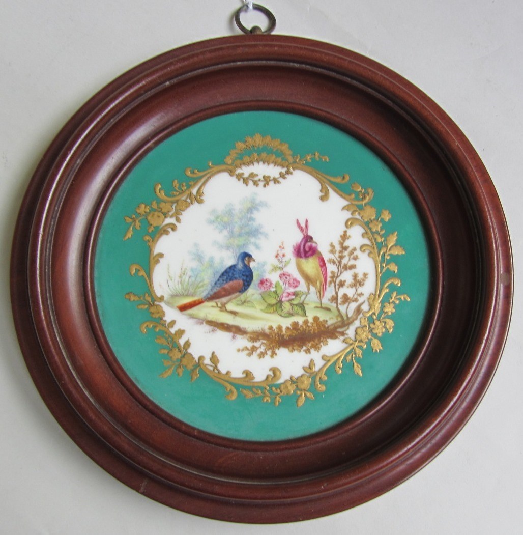 Appraisal: A circular porcelain plaque th century painted in Sevres style