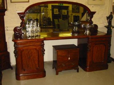 Appraisal: A VICTORIAN MAHOGANY PEDESTAL SIDEBOARD the arched and waisted mirrored