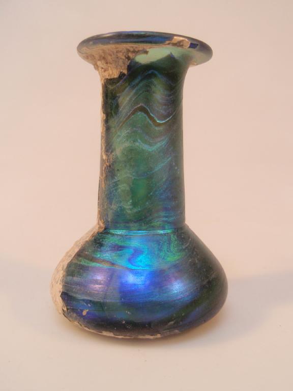 Appraisal: A bright iridescent and heavy green glass 'Jewish' unguentarium the