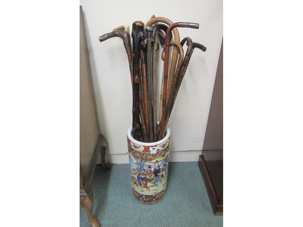 Appraisal: Oriental stick stand with silver mounted and assorted walking sticks