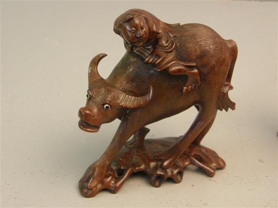 Appraisal: Pair of Asian hard wood figures of bulls with riders