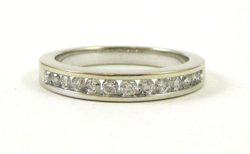 Appraisal: DIAMOND AND FOURTEEN KARAT WHITE GOLD RING channel set with