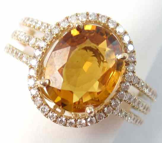 Appraisal: ORANGE SAPPHIRE AND DIAMOND RING k yellow gold with pave'