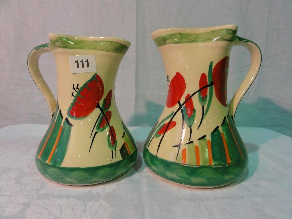 Appraisal: Two graduated Art Deco jugs with painted stylised poppy decoration