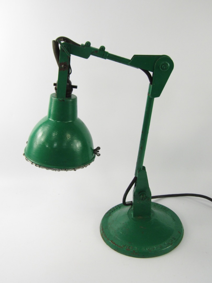 Appraisal: A green painted cast iron anglepoise lamp the F E