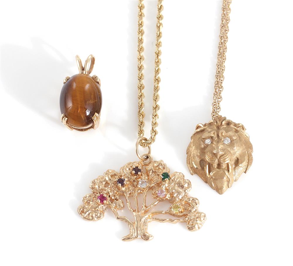 Appraisal: Gemstone and gold pendant and chains x mm cabochon tiger's