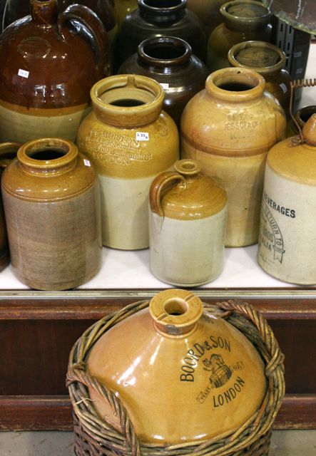 Appraisal: A collection of glazed earthenware vessels including biscuit barrels and