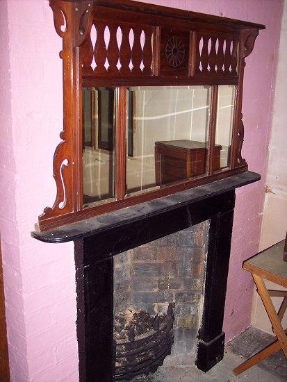 Appraisal: A painted fire surround grate and overmantel mirror with pierced