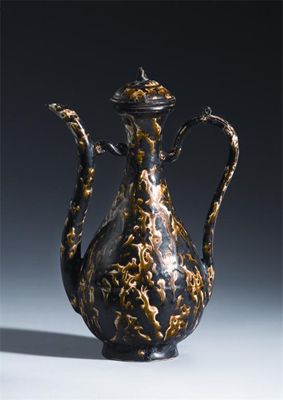 Appraisal: A Chinese pottery brown marble-glazed ewer and cover probably Ming