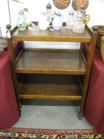 Appraisal: Antique Oak Butler's Trolley Cart triple shelf gallery trim cannonball