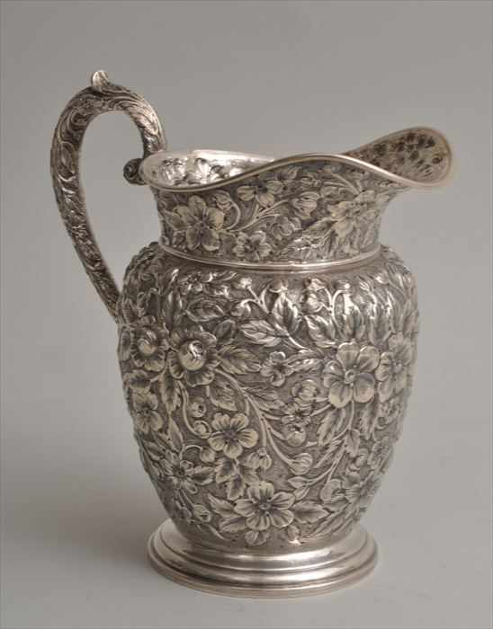 Appraisal: AMERICAN REPOUSS SILVER WATER PITCHER Mark of cross piercing a