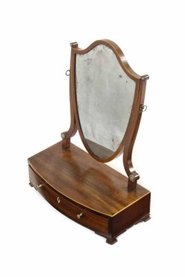 Appraisal: A late George III mahogany toilet mirror the shield shape