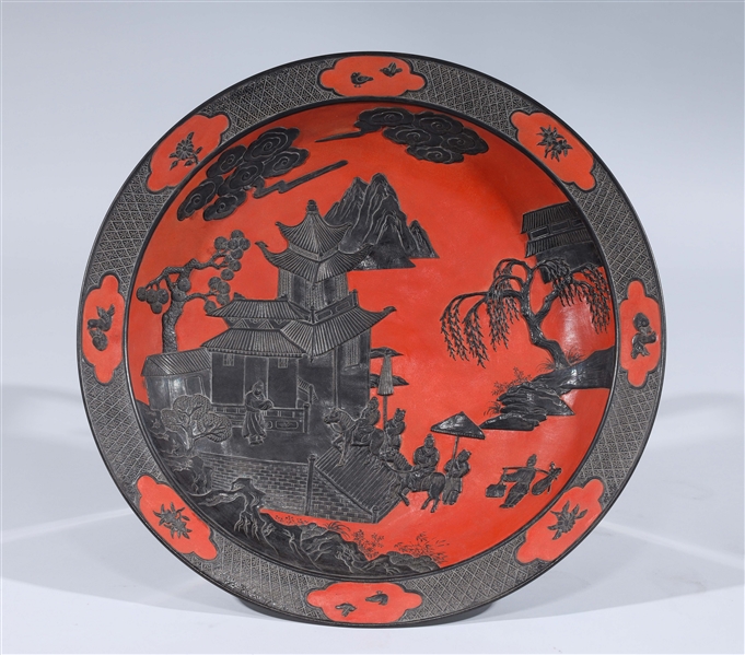 Appraisal: Chinese red and black porcelain charger with courtyard scene and