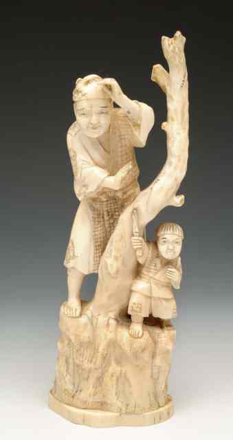 Appraisal: A JAPANESE CARVED IVORY GROUP of father and child beside