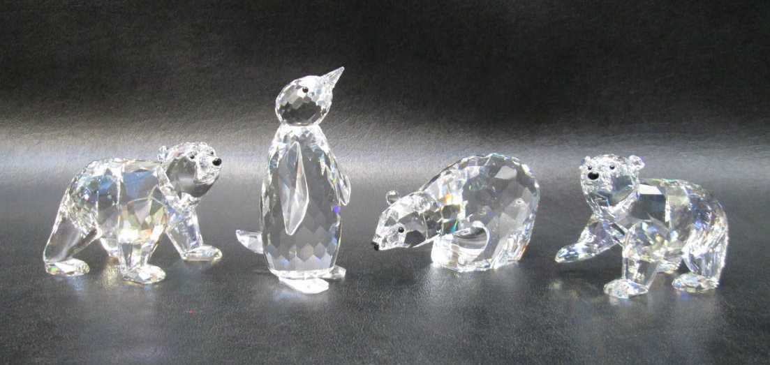 Appraisal: FOUR SWAROVSKI CRYSTAL FIGURINES including Polar Bear Cubs designed by